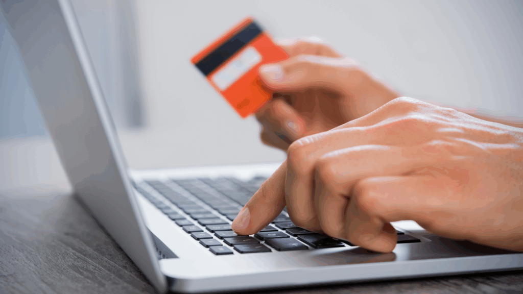 person using online payments to pay online on their computer via credit card